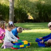 Children playing with toys on Kirkhof Lawn.